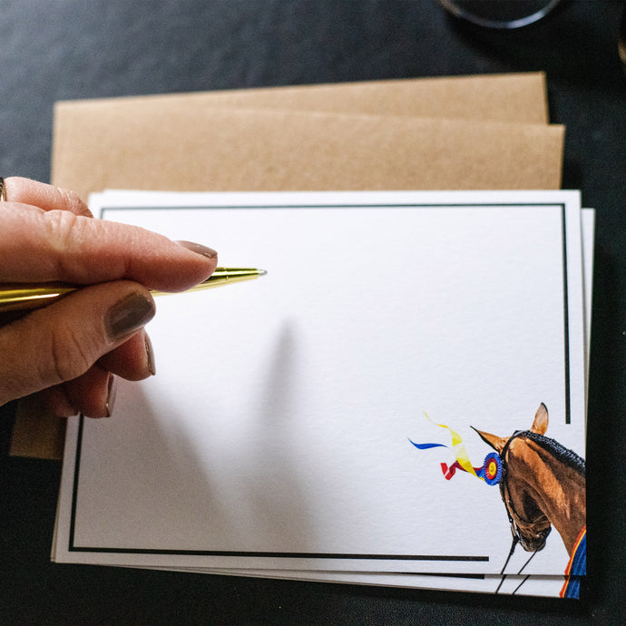 White notecard with brown horse and champion ribbon